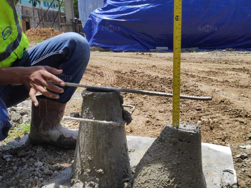 Worker testing the slump of concrete